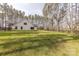 A spacious, well-maintained backyard featuring lush green grass and surrounded by tall, mature trees at 13625 Buster Rd, Stanfield, NC 28163