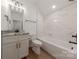 Tastefully designed bathroom featuring marble counters, a shower-tub, and wood laminate flooring at 13625 Buster Rd, Stanfield, NC 28163