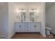 Bathroom features a double vanity with white cabinetry and modern fixtures, flanked by mirrors, and a toilet in the corner at 13625 Buster Rd, Stanfield, NC 28163