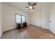 Bedroom with a ceiling fan, wood-look floors, a window with privacy shades, and a desk area at 13625 Buster Rd, Stanfield, NC 28163