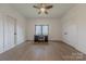 Bedroom with a ceiling fan, wood-look floors, a window, and a desk area, and a closet at 13625 Buster Rd, Stanfield, NC 28163