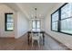 A dining room with wood floors and many large windows at 13625 Buster Rd, Stanfield, NC 28163