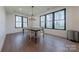 A dining room with wood floors and large windows at 13625 Buster Rd, Stanfield, NC 28163