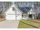 Charming craftsman home featuring white siding, a two-car garage, and a cozy front porch at 13625 Buster Rd, Stanfield, NC 28163