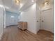 Inviting foyer with wood floors, neutral walls, and a view to the front entrance at 13625 Buster Rd, Stanfield, NC 28163