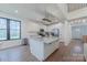 Bright, open kitchen with white cabinets, stainless appliances, island with an eat-in area and a large window at 13625 Buster Rd, Stanfield, NC 28163