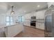 Modern kitchen featuring white cabinets, stainless steel appliances, and an island with marble countertops at 13625 Buster Rd, Stanfield, NC 28163