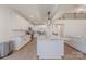 Bright, open kitchen with white cabinetry, an island with marble countertop, stainless steel appliances and an eat-in area at 13625 Buster Rd, Stanfield, NC 28163