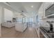 Open-concept kitchen and living room featuring modern finishes, wood floors, and plenty of natural light at 13625 Buster Rd, Stanfield, NC 28163