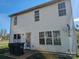 Back exterior reveals a basic yard, weathered siding, and visible utilities, awaiting improvements at 1421 Braveheart Ln, Charlotte, NC 28216