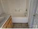 Modest bathroom featuring a tub/shower combination and a simple vanity, ready for renovation at 1421 Braveheart Ln, Charlotte, NC 28216