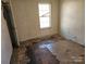 Basic bedroom needing TLC, shows flooring issues and natural light through the window at 1421 Braveheart Ln, Charlotte, NC 28216