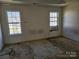 Bedroom featuring two windows and stained carpet at 1421 Braveheart Ln, Charlotte, NC 28216
