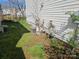 Outdoor view showcasing the home's utilities and some yard space, needs maintenance at 1421 Braveheart Ln, Charlotte, NC 28216