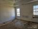 Main bedroom with two windows and stained carpet at 1421 Braveheart Ln, Charlotte, NC 28216