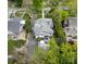 An aerial shot shows the layout of a well maintained home with a long driveway, a fenced yard, and mature trees at 1519 The Plz, Charlotte, NC 28205