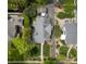 An aerial view shows the layout of a home with well-manicured yards, mature landscaping, and a detached garage at 1519 The Plz, Charlotte, NC 28205
