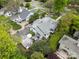 An aerial shot of a well-kept home with a detached garage, a fenced yard, and mature trees in a desirable neighborhood at 1519 The Plz, Charlotte, NC 28205
