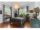 Cozy bedroom with hardwood floors, large windows, and stylish decor at 1519 The Plz, Charlotte, NC 28205