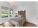 Serene bedroom with hardwood floors, natural light, and a rustic headboard at 1519 The Plz, Charlotte, NC 28205