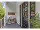 Charming front porch showcasing plants, decor, and a black front door at 1519 The Plz, Charlotte, NC 28205
