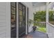 Inviting front porch with black door and nice decorative potted plants at 1519 The Plz, Charlotte, NC 28205