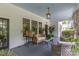 Charming front porch featuring a cozy seating area with plants and decorative touches at 1519 The Plz, Charlotte, NC 28205