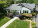 Picturesque home featuring a well-kept lawn, mature bushes, and inviting curb appeal at 1519 The Plz, Charlotte, NC 28205