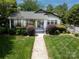 Beautiful home with a verdant front yard and walkway leading to the charming entrance at 1519 The Plz, Charlotte, NC 28205