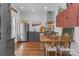 Rustic kitchen featuring stainless steel appliances, open shelving, and a dining table at 1519 The Plz, Charlotte, NC 28205