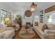 Cozy living room showcasing hardwood floors, a fireplace, and natural light from the surrounding windows at 1519 The Plz, Charlotte, NC 28205