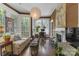 Cozy living room with large windows, fireplace, wood accents, and stylish decor at 1519 The Plz, Charlotte, NC 28205