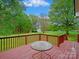 Backyard deck overlooking a spacious lawn with mature trees and a storage shed at 1520 Venture Oaks Ln, Monroe, NC 28110
