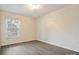 Sunlit bedroom with neutral walls, light wood floors and a bright window at 1520 Venture Oaks Ln, Monroe, NC 28110