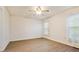 Bright bedroom featuring light-colored walls, hardwood floors, and two windows at 1520 Venture Oaks Ln, Monroe, NC 28110