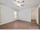Spacious bedroom with hardwood floors, ceiling fan, and white trim at 1520 Venture Oaks Ln, Monroe, NC 28110