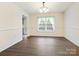 Bright dining room with wood-look floors and a modern chandelier fixture at 1520 Venture Oaks Ln, Monroe, NC 28110