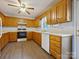 Functional kitchen with wood cabinets, white countertops, and modern appliances at 1520 Venture Oaks Ln, Monroe, NC 28110