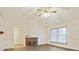 Bright living room featuring a brick fireplace, large window, and white walls at 1520 Venture Oaks Ln, Monroe, NC 28110