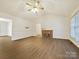 Open living room with vaulted ceilings, cozy fireplace, and wood-look flooring at 1520 Venture Oaks Ln, Monroe, NC 28110