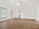 Spacious living room with neutral walls, wood-look flooring, and a ceiling fan at 1520 Venture Oaks Ln, Monroe, NC 28110