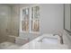 Bright bathroom featuring large shower with glass door and seat, white quartz countertop, and a double window at 157 Silver Falls Dr, Troutman, NC 28166