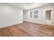 Bright bedroom featuring hardwood floors, and a double window, with a tiled bathroom visible at 157 Silver Falls Dr, Troutman, NC 28166