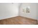 Bright bedroom featuring hardwood floors, white walls, and natural light from a double window at 157 Silver Falls Dr, Troutman, NC 28166