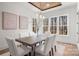 Bright dining room with modern chandelier, natural light, and views of the surrounding landscape at 157 Silver Falls Dr, Troutman, NC 28166