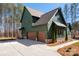 Attractive two-story home with a mix of wood and stone exterior, complemented by a well-maintained landscape at 157 Silver Falls Dr, Troutman, NC 28166