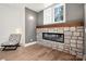 Cozy reading nook with a stone fireplace and a comfortable chair at 157 Silver Falls Dr, Troutman, NC 28166