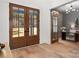 Bright foyer with hardwood floors, glass paneled double doors, and entry to the study room at 157 Silver Falls Dr, Troutman, NC 28166