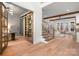 Bright, open foyer with hardwood floors, an office with glass doors, and the stairs to the second level at 157 Silver Falls Dr, Troutman, NC 28166