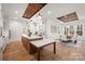 Open kitchen with island, wood accents, custom lighting, and easy access to the dining area at 157 Silver Falls Dr, Troutman, NC 28166